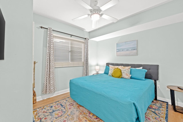 bedroom with light hardwood / wood-style floors and ceiling fan