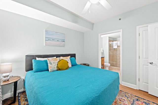 bedroom featuring ensuite bath, ceiling fan, and light wood-type flooring