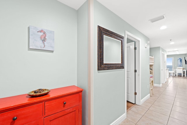 corridor featuring light tile floors