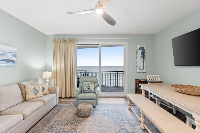 living room featuring a water view, ceiling fan, and hardwood / wood-style flooring