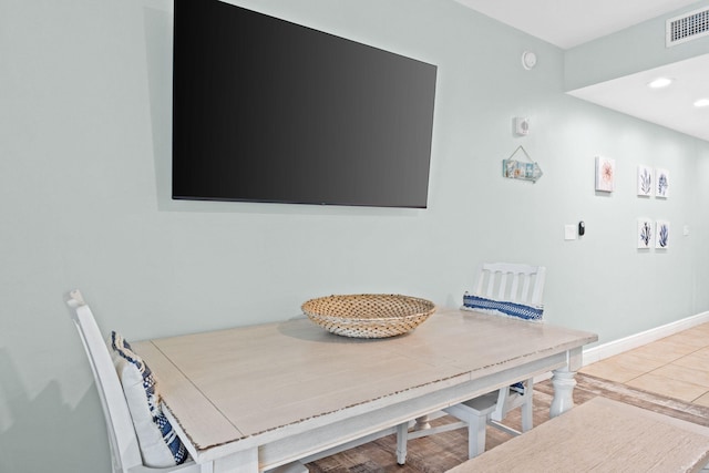 dining space featuring light tile floors