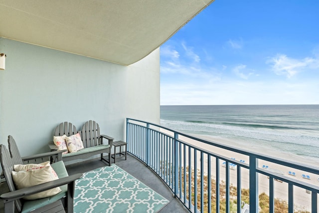 balcony with a water view and a beach view