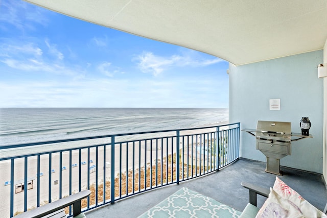 balcony with a water view and a beach view