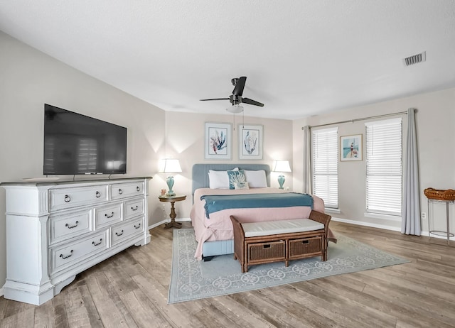 bedroom featuring light hardwood / wood-style flooring and ceiling fan