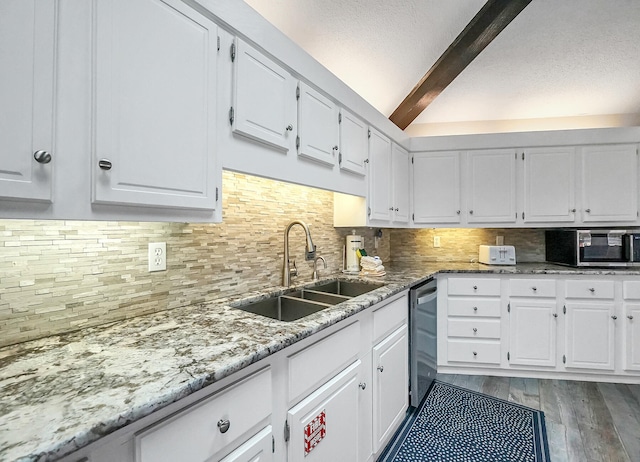 kitchen featuring white cabinets, beamed ceiling, light wood-type flooring, stainless steel appliances, and sink