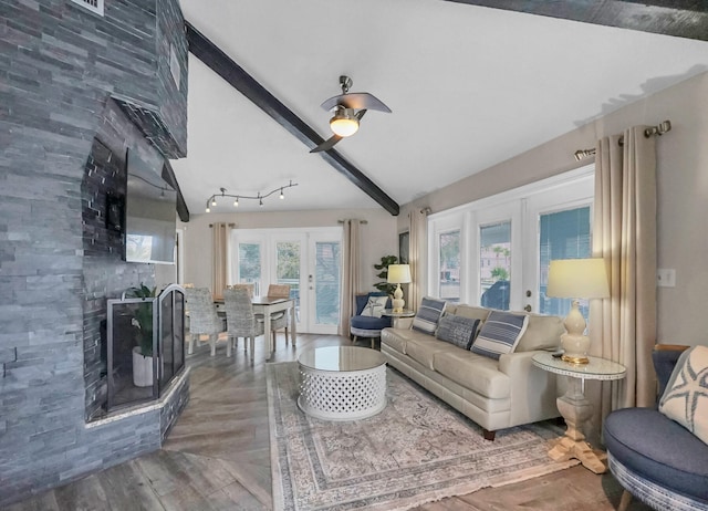 living room with tile walls, french doors, vaulted ceiling with beams, dark wood-type flooring, and rail lighting