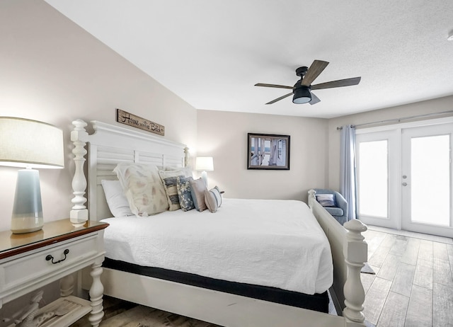 bedroom featuring french doors, wood-type flooring, and ceiling fan