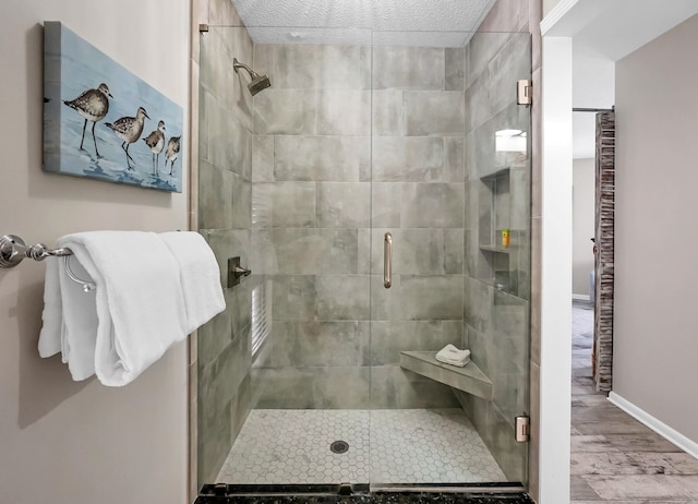 bathroom featuring a shower with shower door and hardwood / wood-style floors