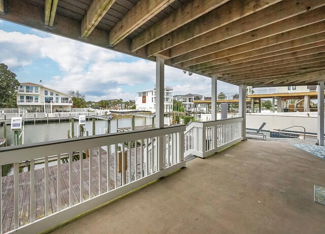 balcony featuring a water view and a dock