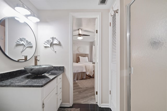 bathroom with ceiling fan, vanity, and hardwood / wood-style floors