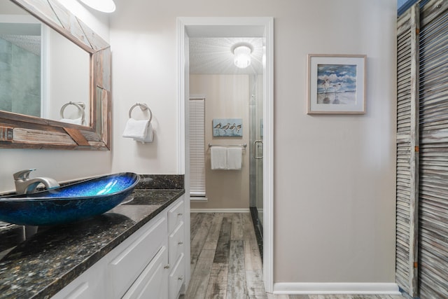 bathroom featuring vanity and hardwood / wood-style flooring