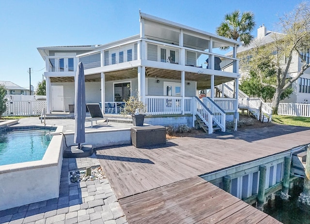 back of house featuring a fenced in pool, a patio, and a balcony