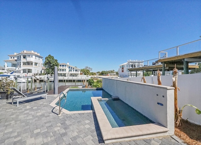 view of pool with a patio and a water view