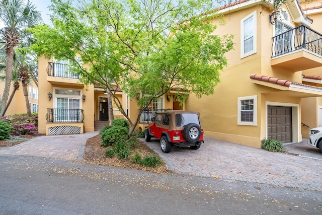 view of front of house featuring a garage and a balcony