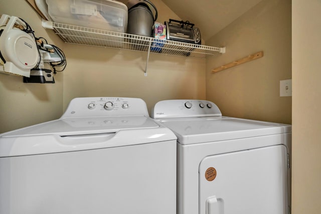 clothes washing area featuring separate washer and dryer