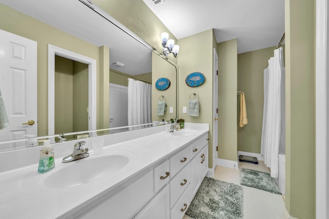 bathroom with tile patterned flooring, double sink vanity, and shower / bathtub combination with curtain