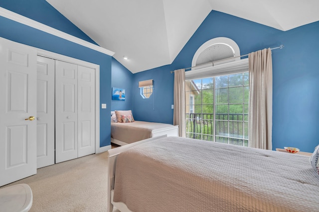 bedroom with carpet, a closet, and lofted ceiling