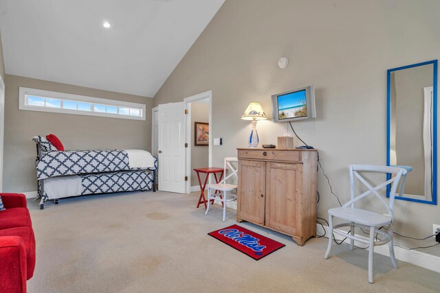 carpeted bedroom with high vaulted ceiling