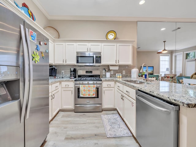 64 Vantage Pt Unit 64, Miramar Beach, FL 32550 - kitchen featuring crown molding, a peninsula, tasteful backsplash, a sink, and appliances with stainless steel finishes