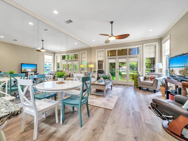 dining area featuring crown molding, french doors, ceiling fan, and light hardwood / wood-style floors