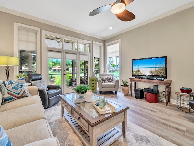 living room featuring light hardwood / wood-style flooring, ceiling fan, french doors, and crown molding