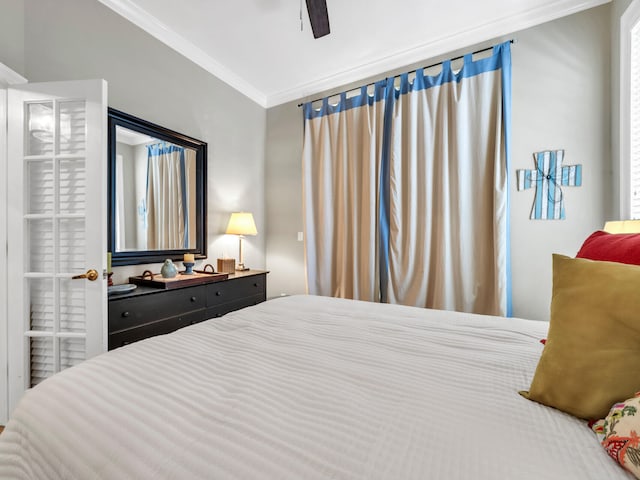 bedroom with ornamental molding and ceiling fan