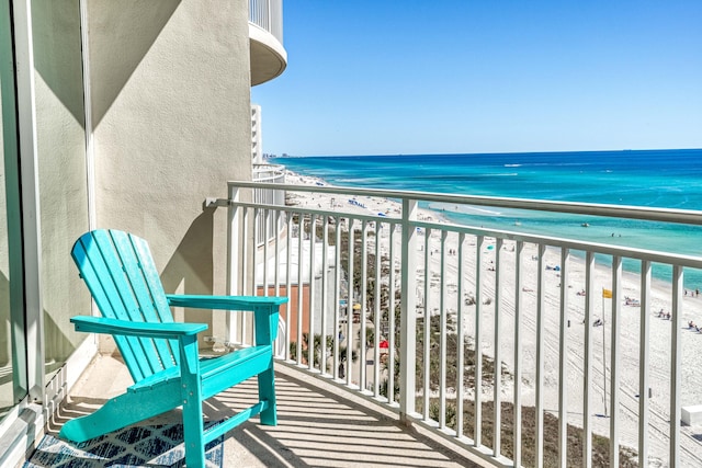 balcony with a water view and a beach view