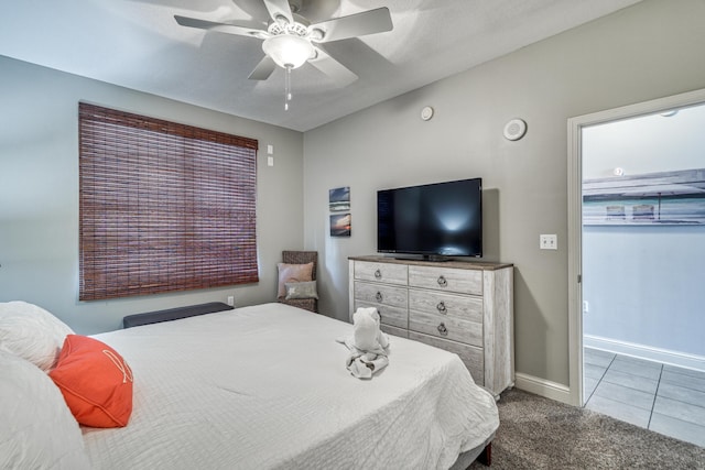 tiled bedroom featuring ceiling fan