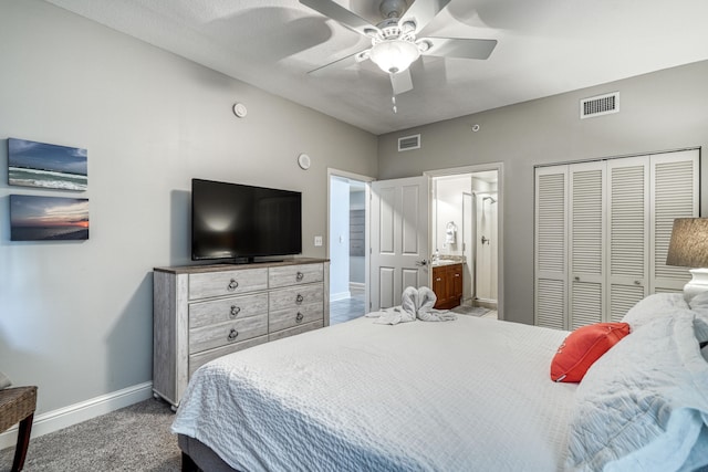 carpeted bedroom featuring ensuite bath, a closet, and ceiling fan