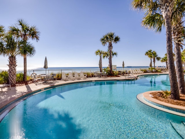 view of pool featuring a patio and a water view