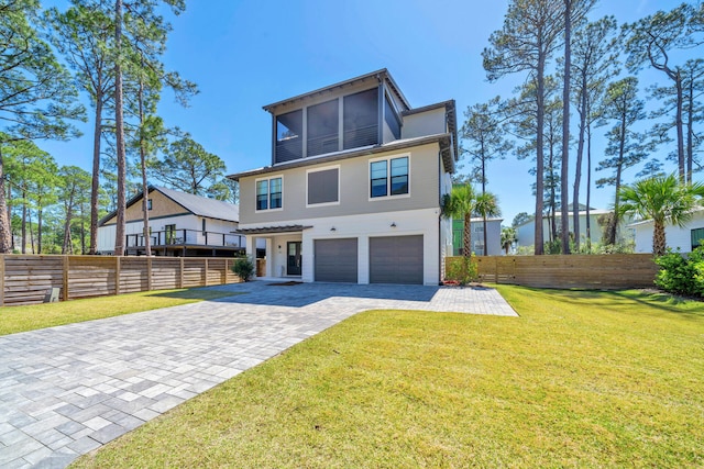 view of front of house featuring a garage and a front lawn