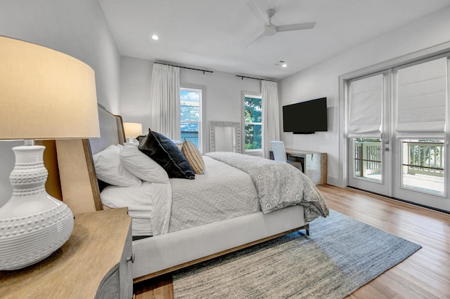 bedroom featuring hardwood / wood-style floors, ceiling fan, and access to outside