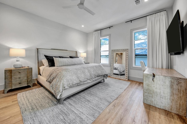 bedroom with wood-type flooring and ceiling fan