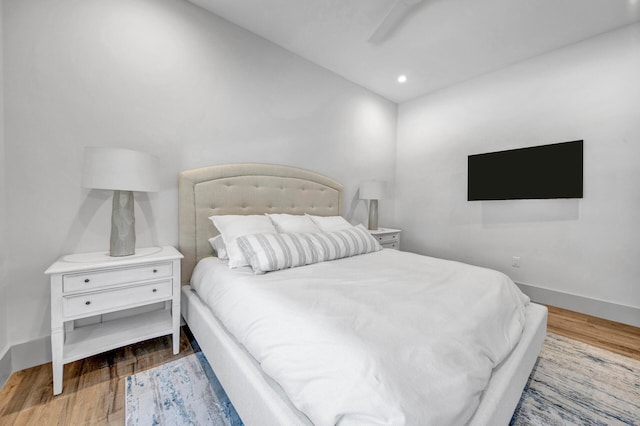 bedroom featuring ceiling fan and hardwood / wood-style flooring