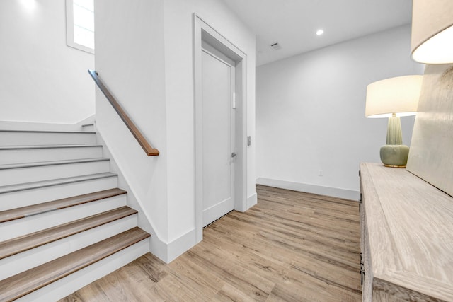 stairway featuring light hardwood / wood-style flooring