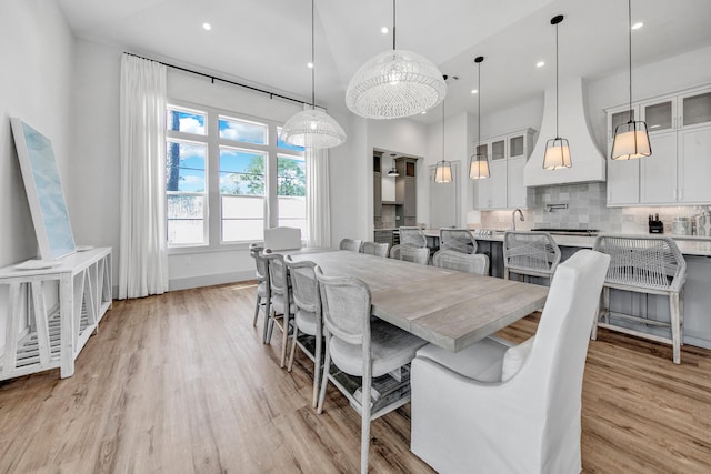 dining space with light hardwood / wood-style floors and sink