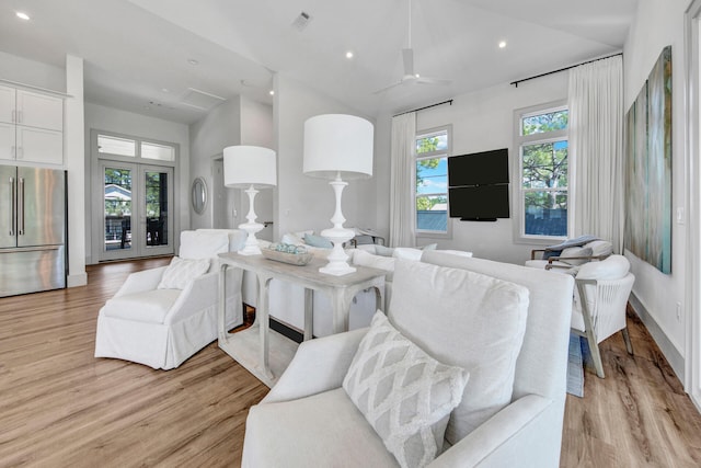 living room featuring ceiling fan and light hardwood / wood-style floors