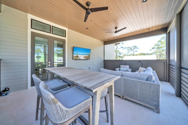 sunroom / solarium with wood ceiling, french doors, and ceiling fan