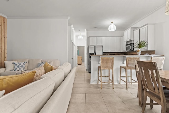 living room with crown molding and light tile floors