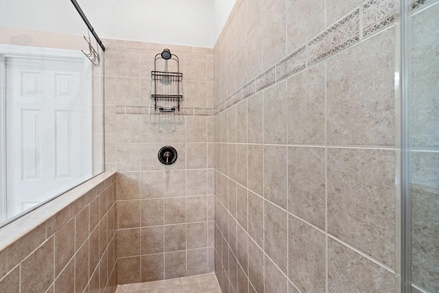 bathroom with a tile shower