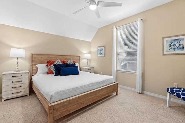 carpeted bedroom featuring ceiling fan, vaulted ceiling, and multiple windows