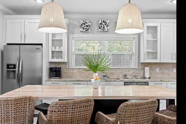 kitchen with a kitchen bar, tasteful backsplash, and white cabinets