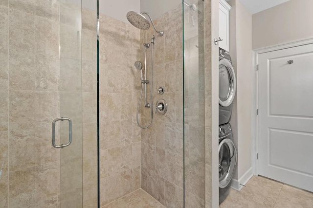 laundry room with light tile flooring and stacked washer and clothes dryer