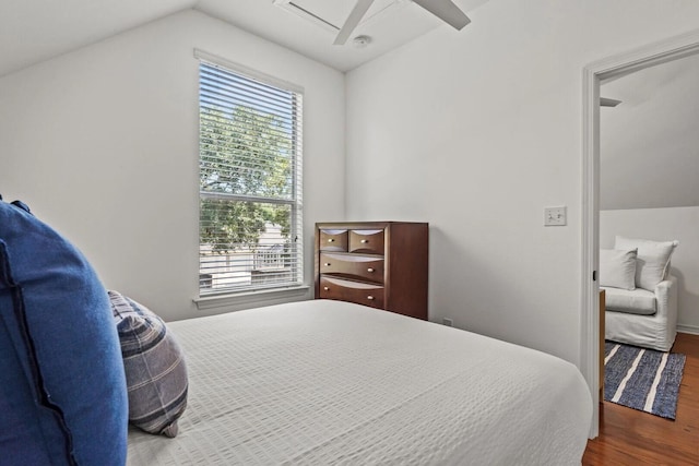 bedroom featuring dark wood-type flooring, ceiling fan, and vaulted ceiling