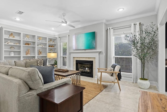 living room featuring ornamental molding, built in shelves, ceiling fan, and light tile flooring