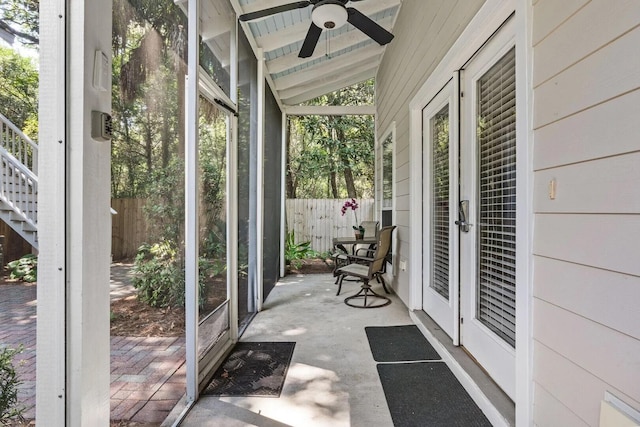 sunroom / solarium featuring lofted ceiling and ceiling fan