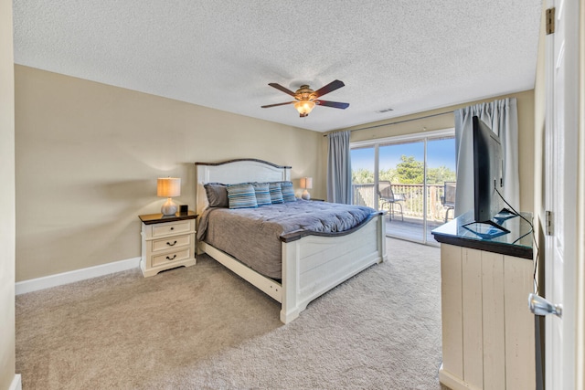 carpeted bedroom with a textured ceiling, ceiling fan, and access to outside