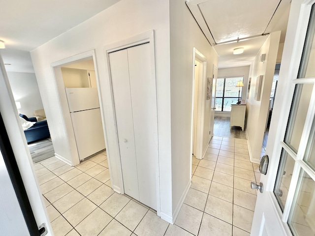 corridor featuring light tile patterned floors