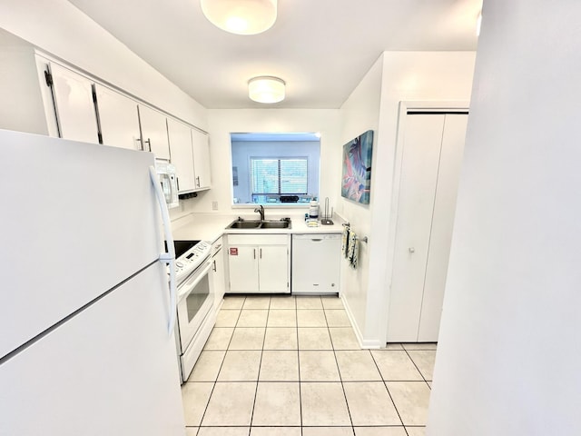 kitchen featuring white cabinetry, light tile patterned flooring, white appliances, and sink