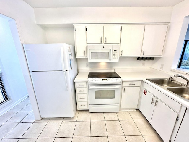 kitchen featuring white cabinetry, light tile patterned flooring, white appliances, and sink